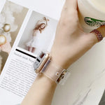 Transparent TPU watchband for Apple Watch worn on wrist with coffee cup and magazine background.