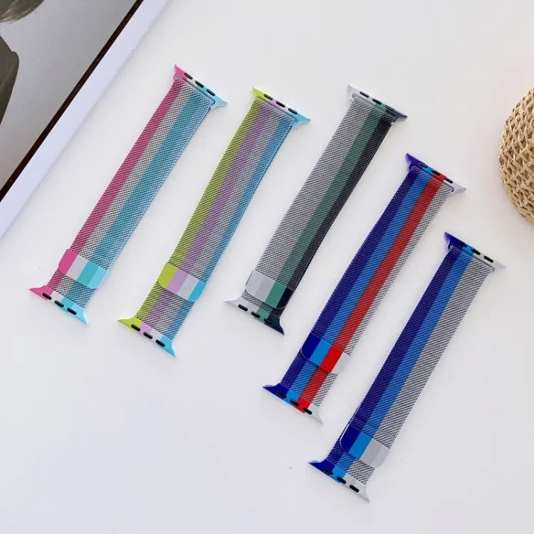 Four-color Milanese replacement strap for Apple Watch displayed in a stylish arrangement on a tabletop.