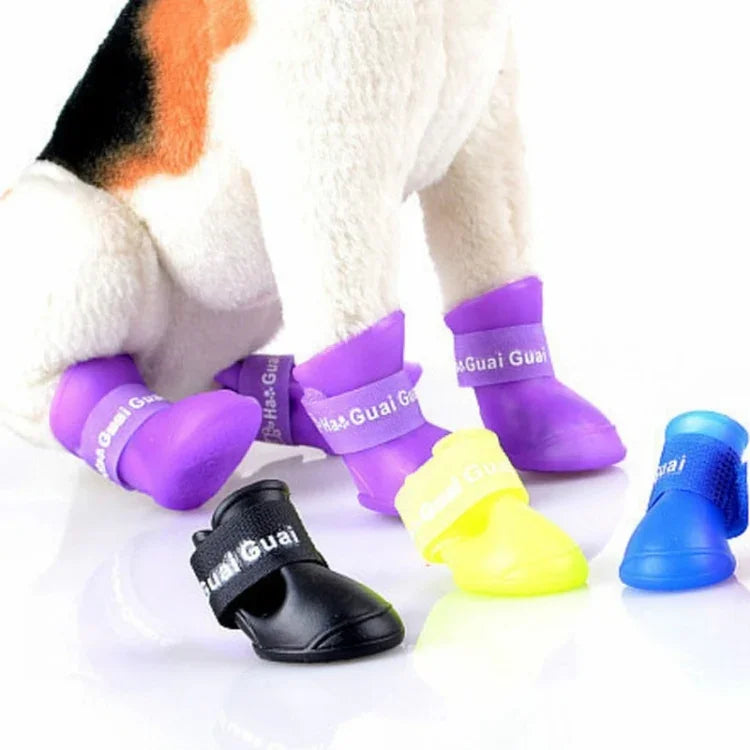 Colorful waterproof rubber dog shoes for pets, featuring black, purple, yellow, and blue styles, perfect for rainy days.
