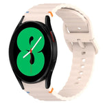 Wavy grain stitched silicone watch band for Samsung Galaxy Watch 4, shown on a smartwatch with a black face.